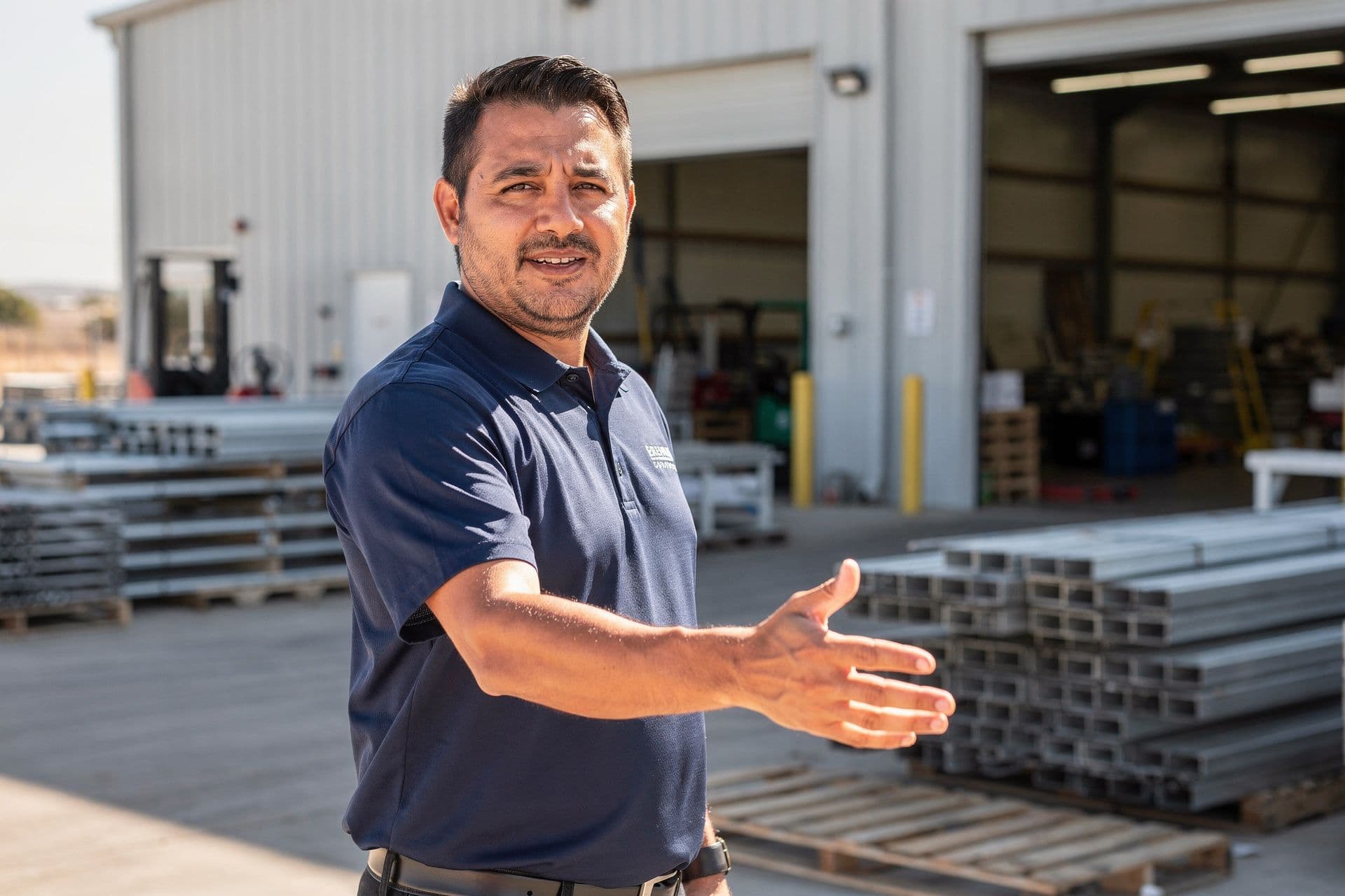 Marco Delgado, Founder & CEO of Premium Manufacturing Solutions Inc. a manufacturing business in Bakersfield, California standing proudly