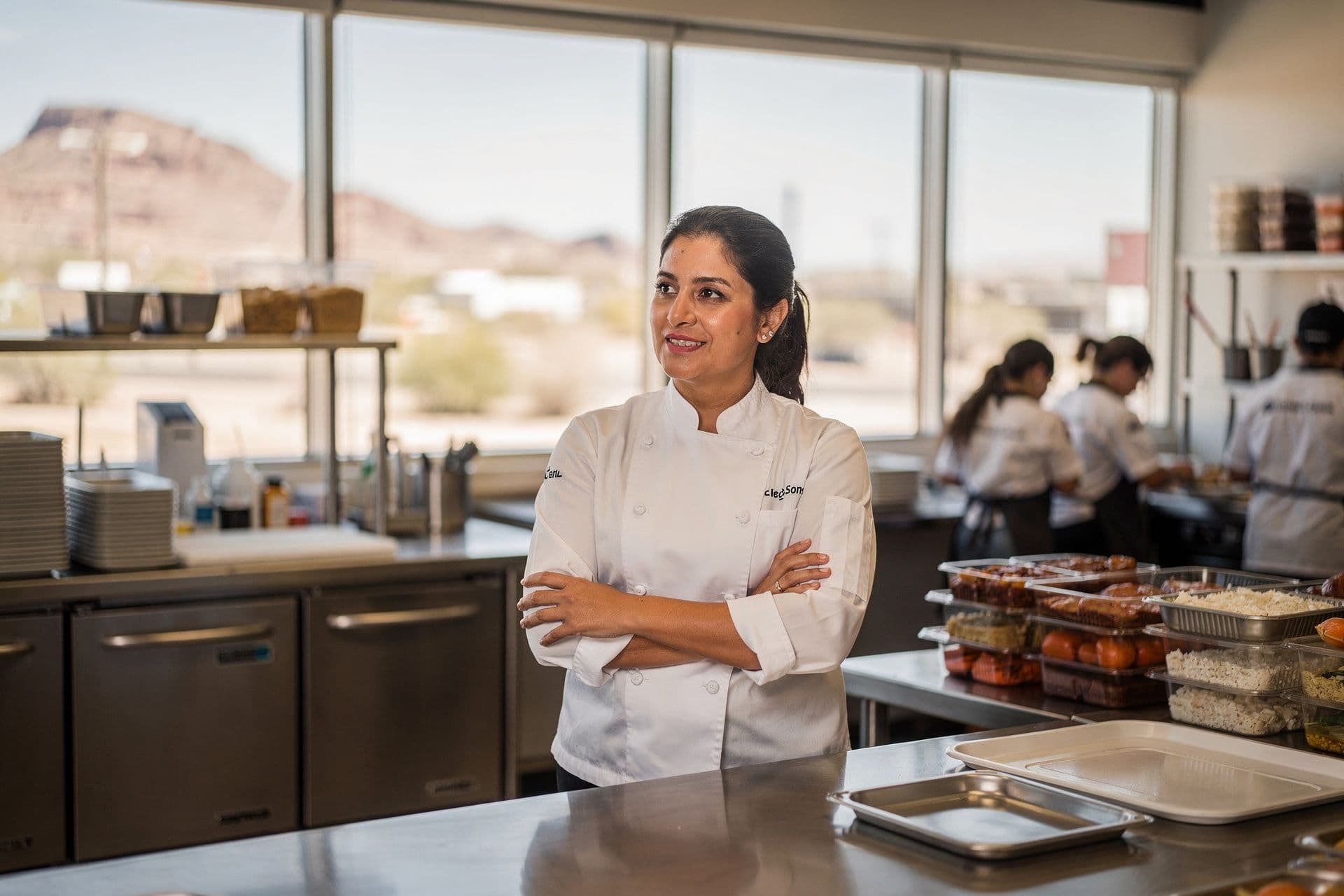Valerie Santos, Executive Chef and Owner of Frances & Sons Catering Company a food-services business in Arizona standing at ease